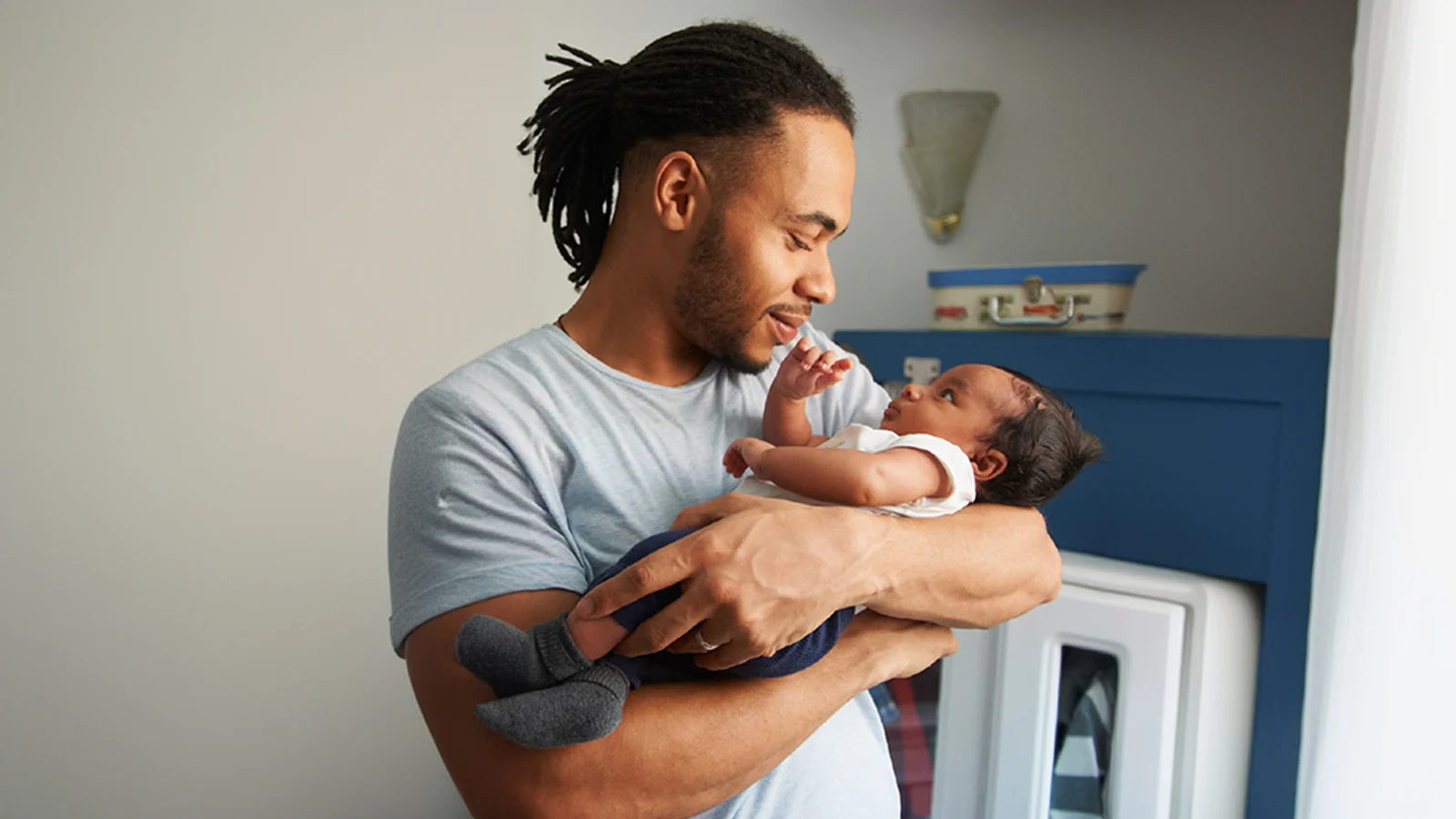 Father holding his newborn baby in his arms