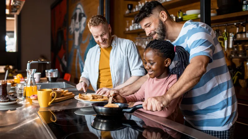 Why we’re different - Partners cooking with daughter in the kitchen