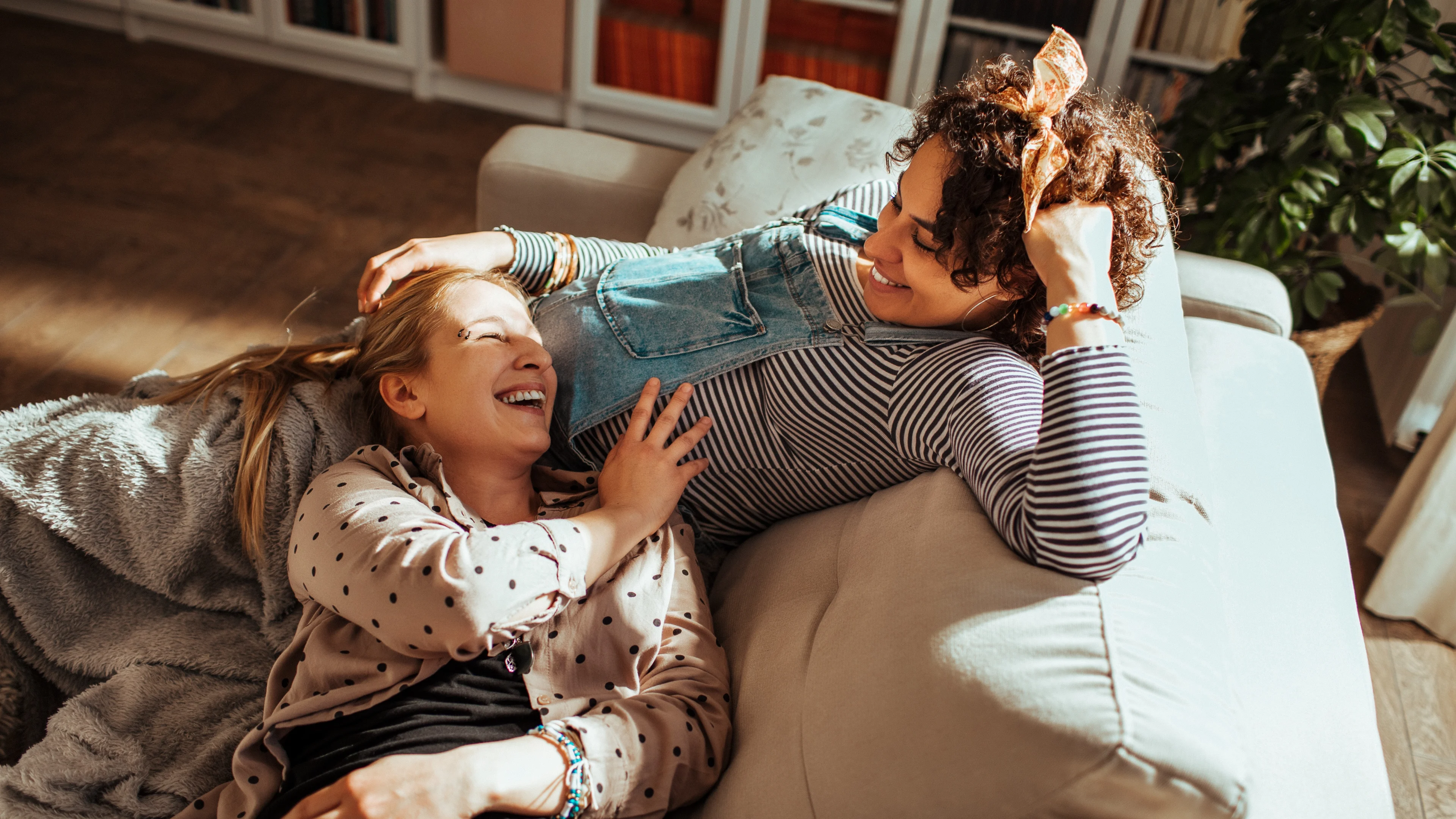 What couples need but hate to talk about - Pregnant couple relaxing on a couch