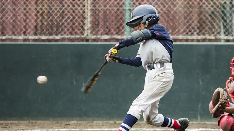 boy hitting baseball