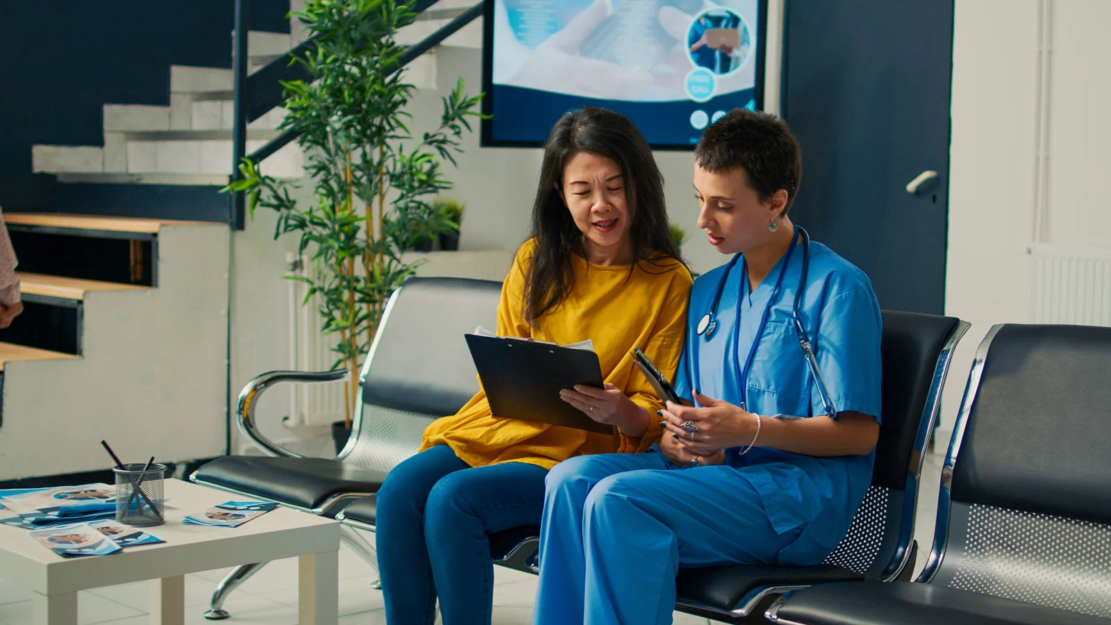 Woman examines papers with doctor