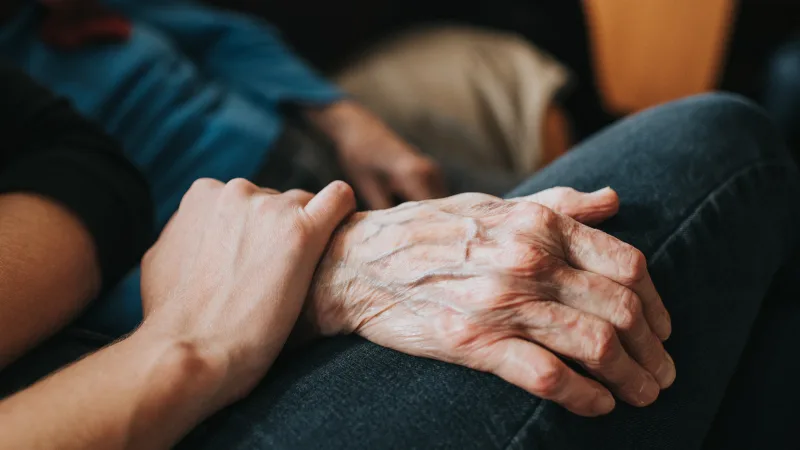 Caregivers: Make your well-being a priority with these 5 tips - Caregiver gently reaching for loved ones arm