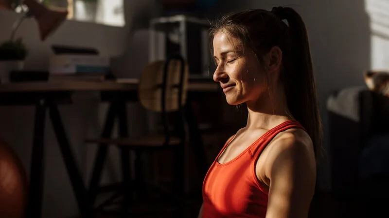 Mental wellness - Woman peacefully meditating and smiling