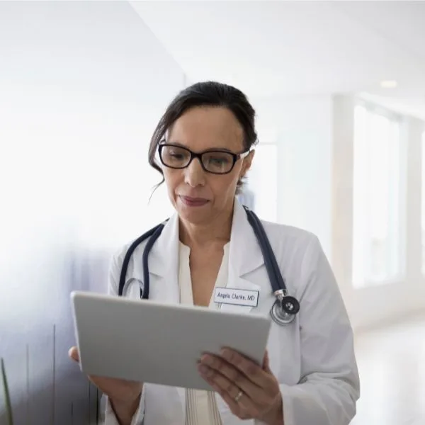 Female doctor reviewing patient chart .
