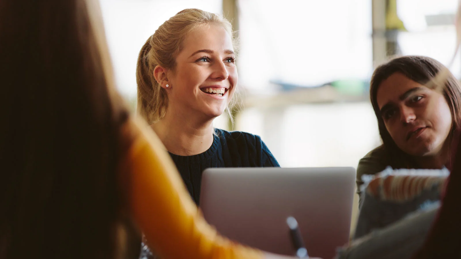 Woman on laptop smiling 