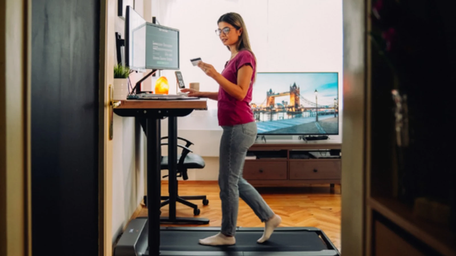 Woman working while walking on treadmill