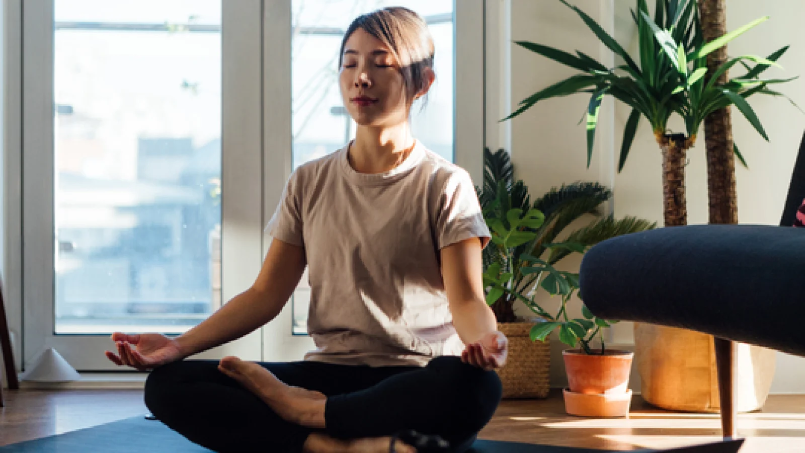 Woman practicing yoga at home.