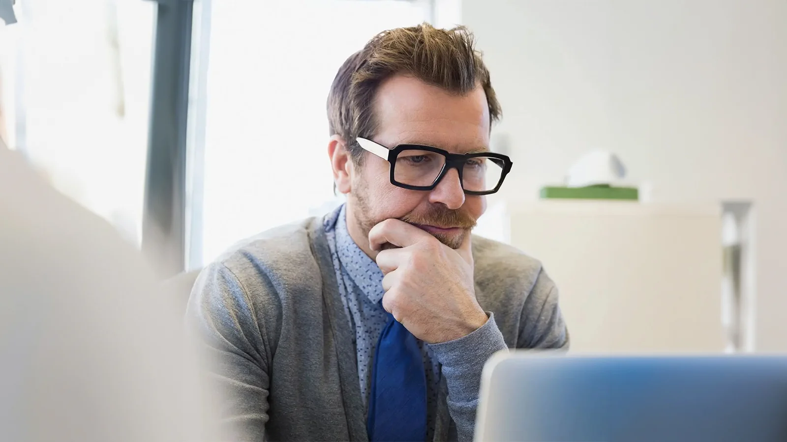 What’s the difference between long term and short term disability insurance? - Man in front of his computer working