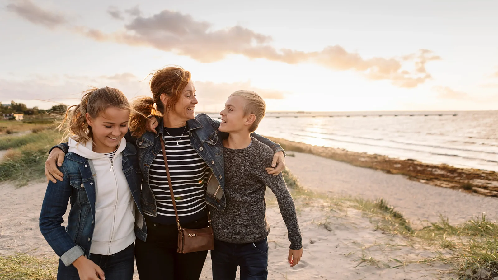 A mother with her arms around her two daughters