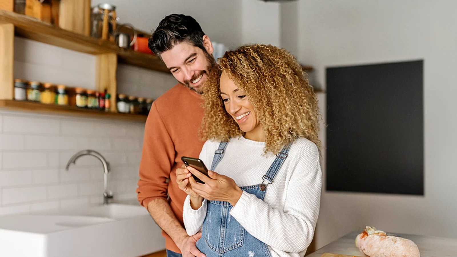Smiling couple looking a phone together