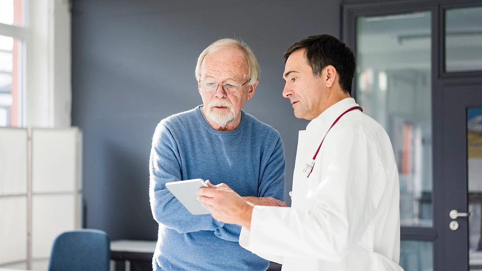 Doctor with patient in exam