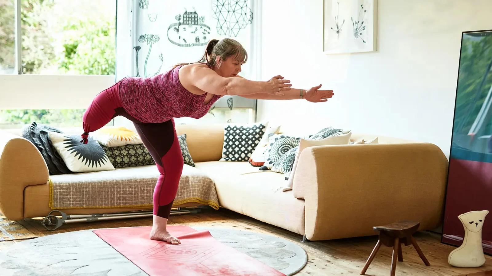Woman with an amputated leg stretching at home.