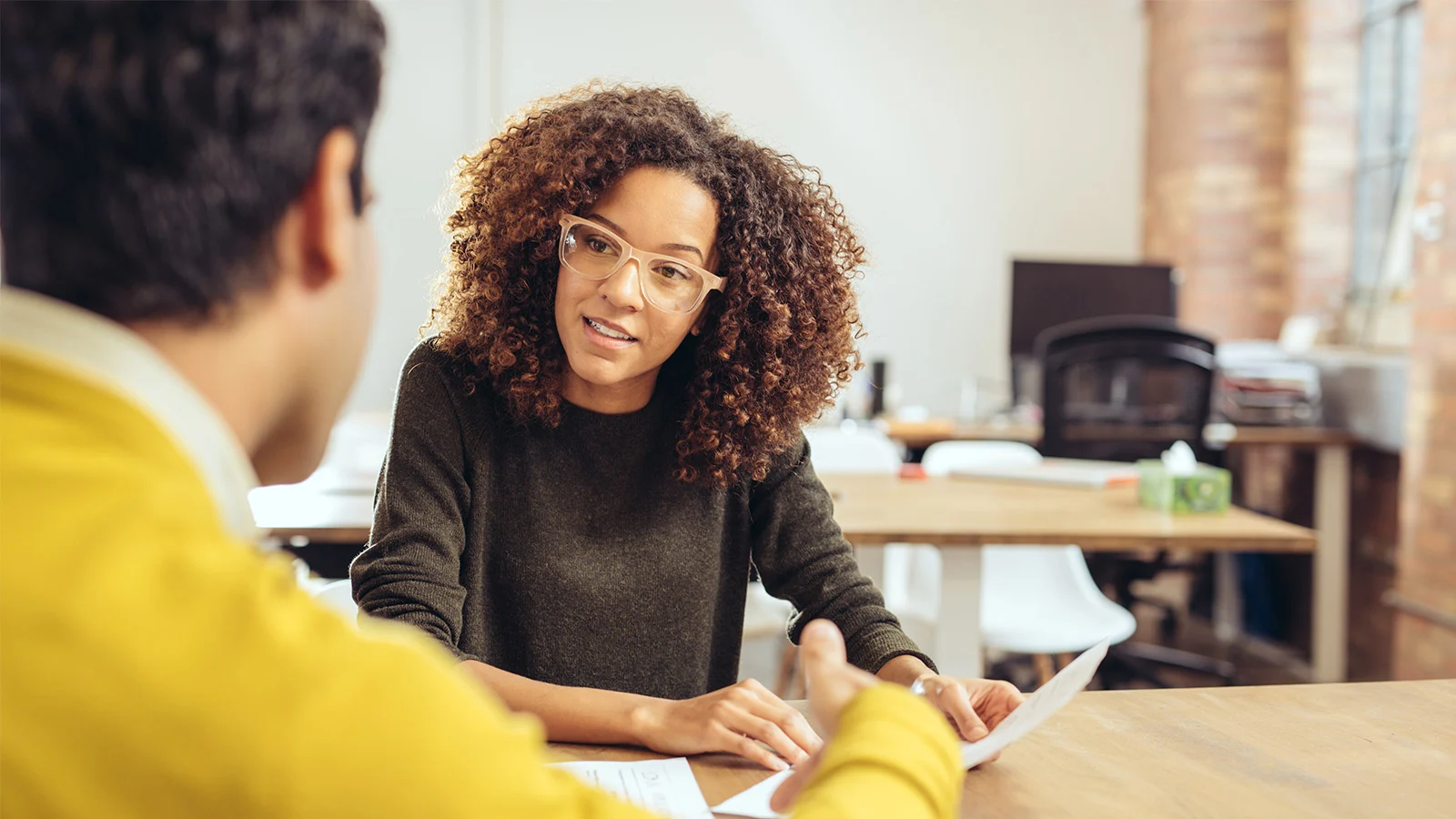 Built from financial strength - Woman and man reviewing document sitting at a table