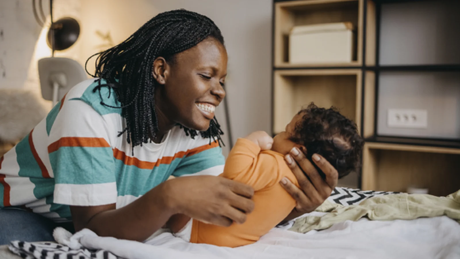 New mom smiling at her baby.