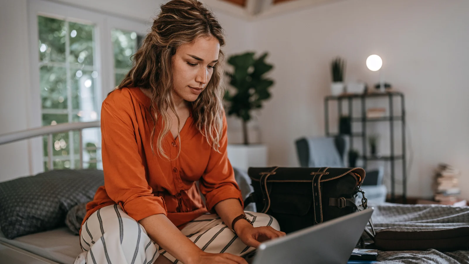 Woman looking on laptop at home.