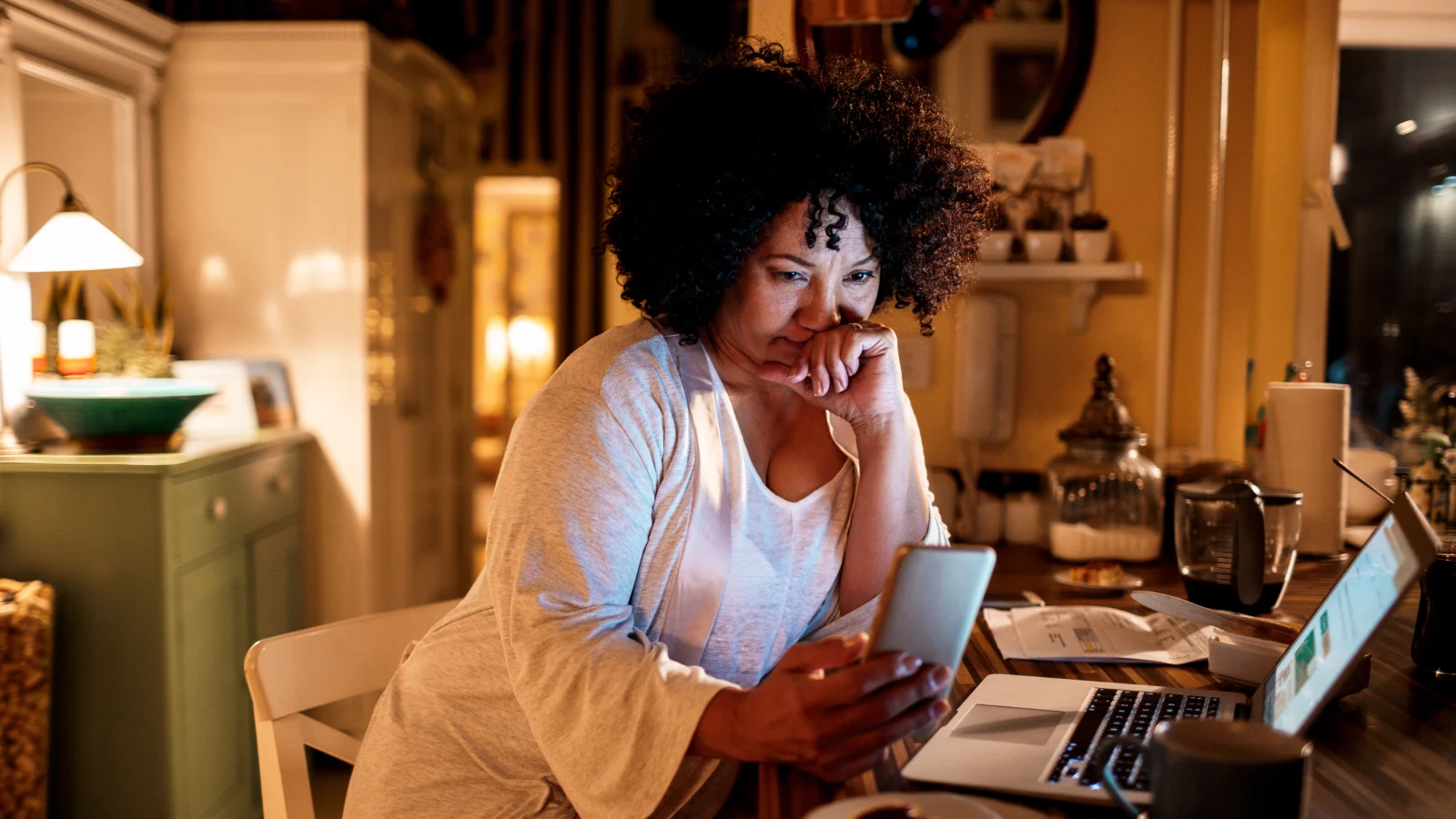 Woman looking at her phone while working from home