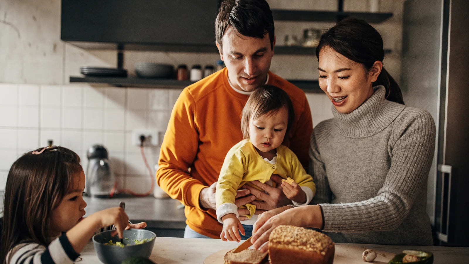Family in kitchen preparing meal