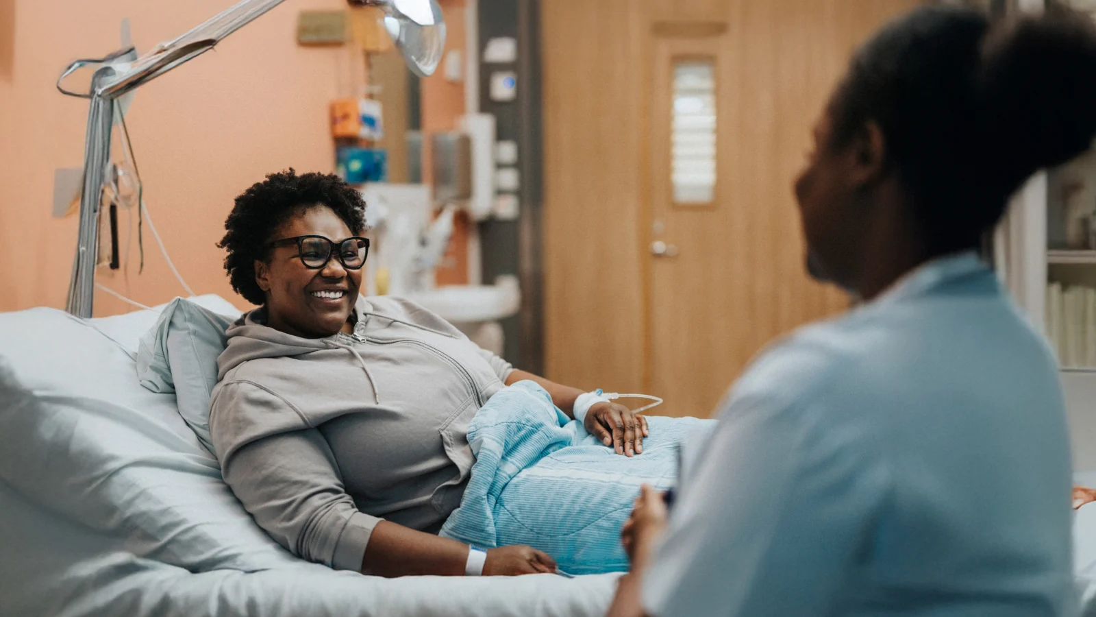 Woman in a hospital bed.