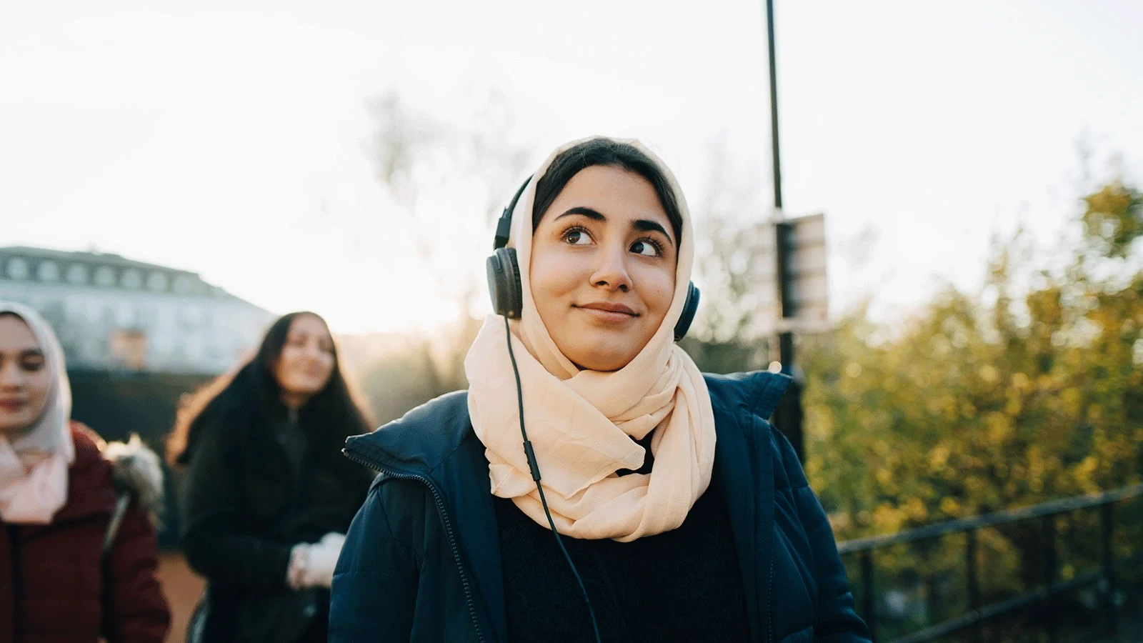 Woman walking with headphones on