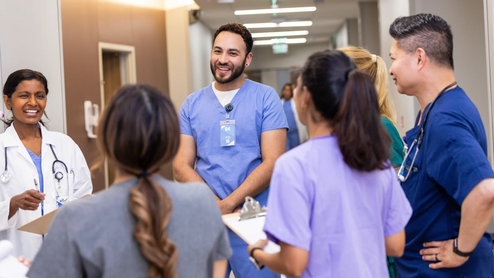 Medical residents talking to a doctor in the hospital