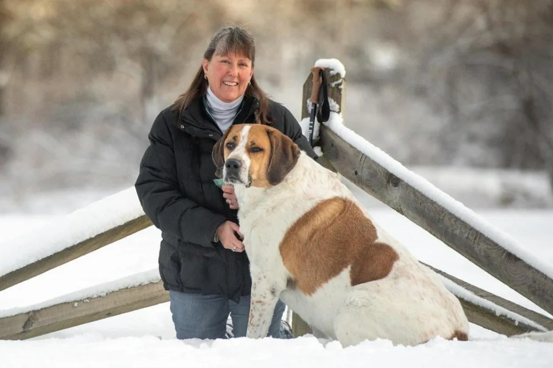 Heather Drake and her dog standing in the snow