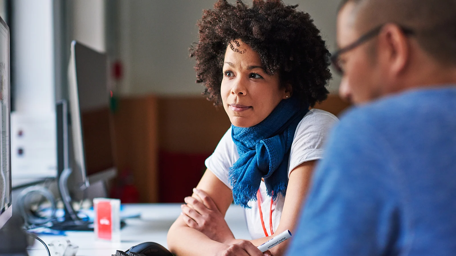 Two employees looking at a laptop together