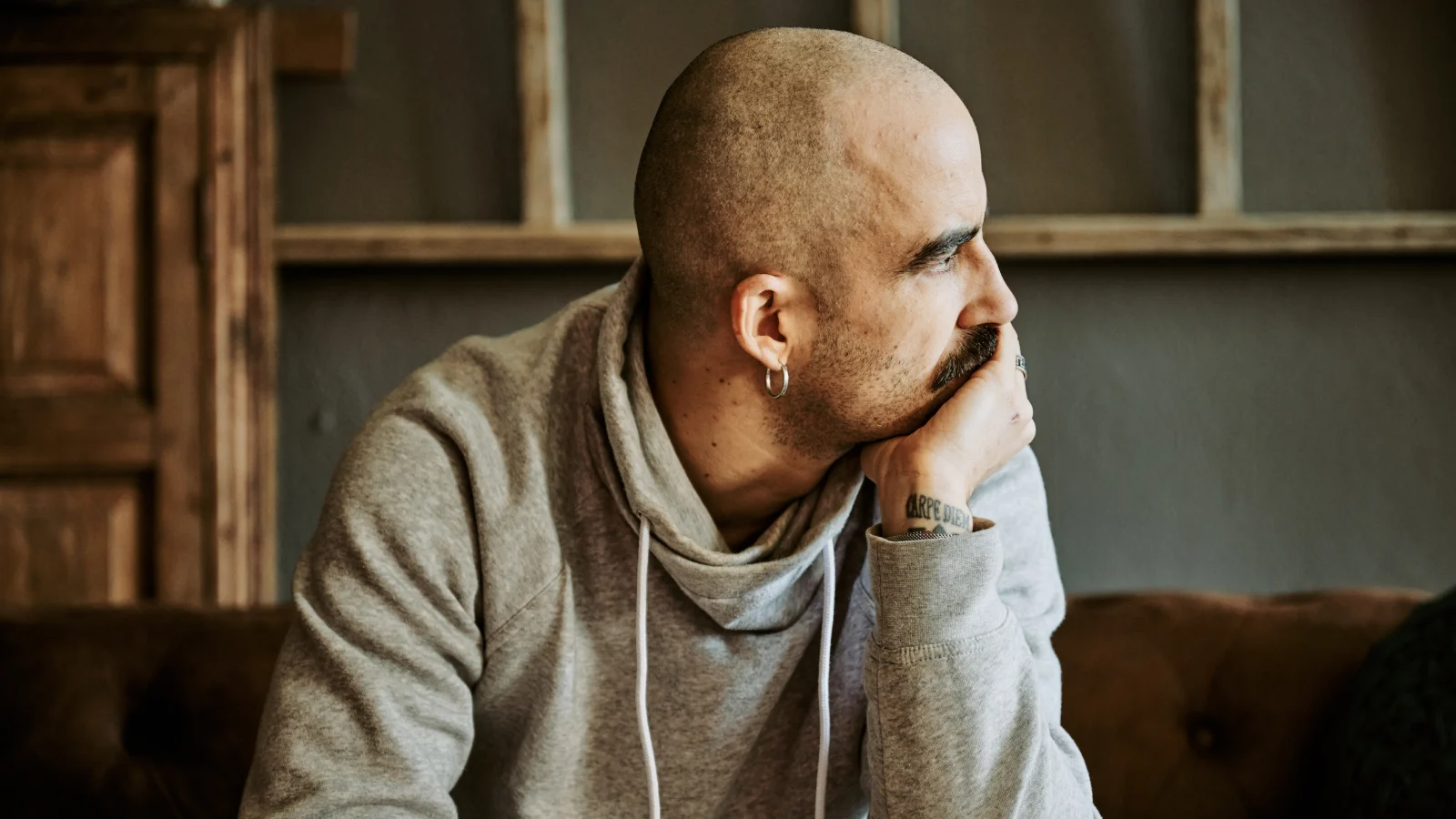 Man with cancer looking pensive.