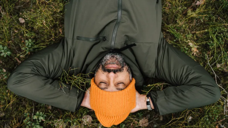 How to navigate your mental health decisions - Man laying in the grass relaxing with eyes closed