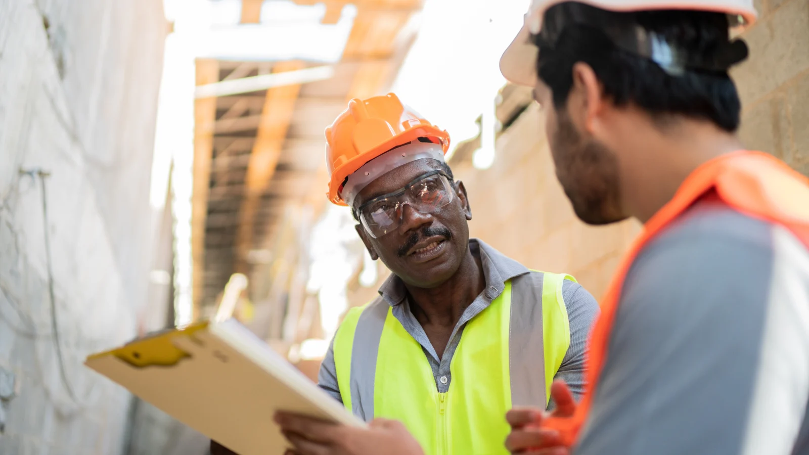 Two construction workers talking to each other