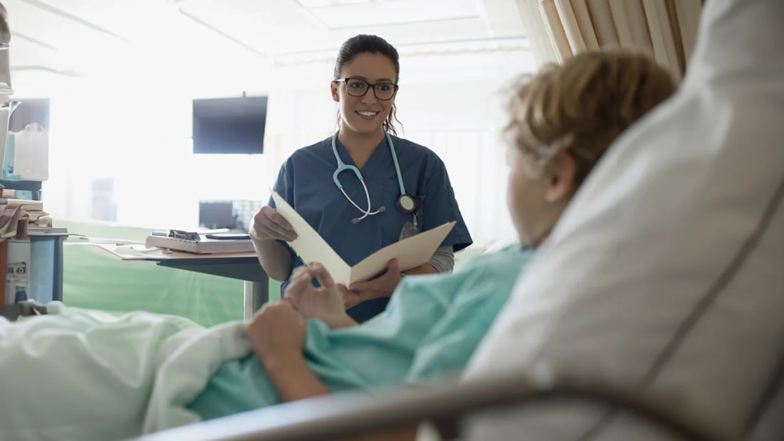 Supplemental health insurance - Doctor talking to child patient.