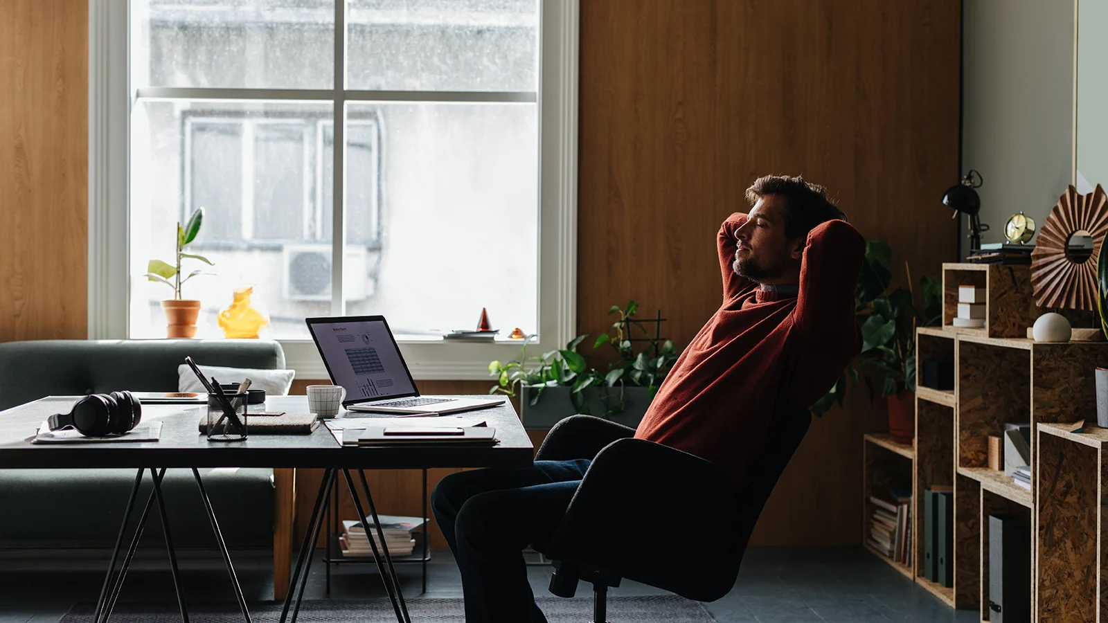 man relaxing at computer desk