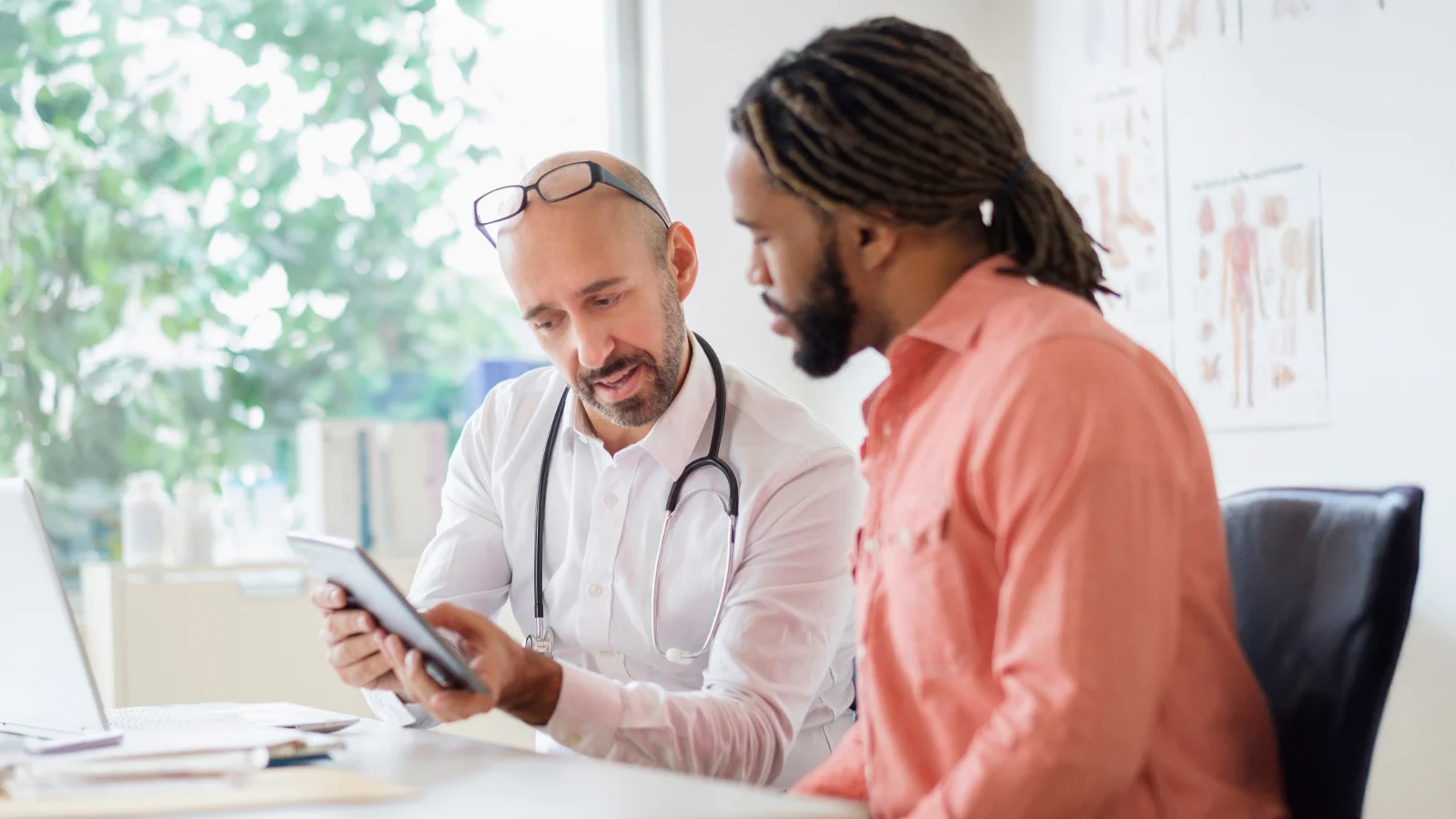 Health Care Industry Check-up: Exploring health care workers' well-being and what employers can do to help - Doctor giving consultation to patient
