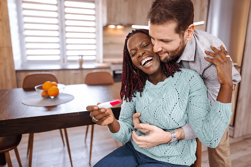 couple looking at a pregnancy test