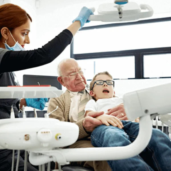 A grandfather with his grandson at the dentist office.