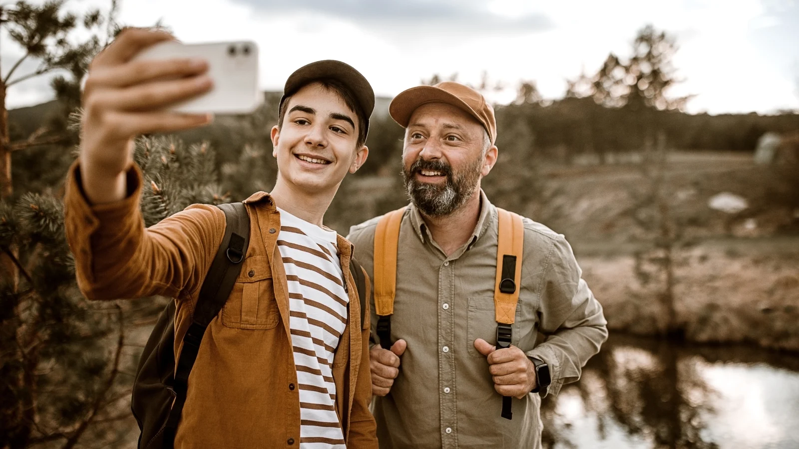 Father and his son taking a selfie while out hiking.