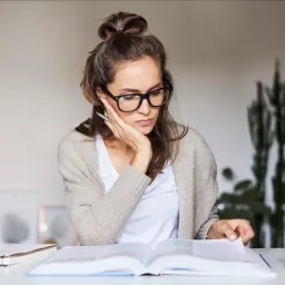 Woman wearing glasses and reading.