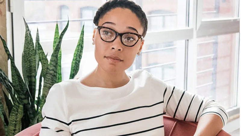 Eight behaviors to help increase financial and emotional confidence - Woman casually sitting in office chair