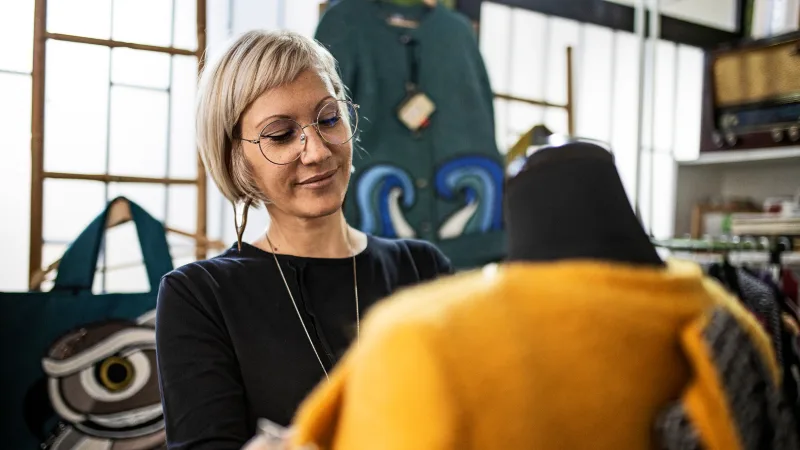 Even if you have a medical plan, you still need vision insurance - Woman wearing glasses and working on apparel design in studio