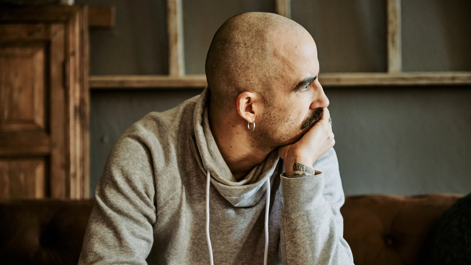 Man with cancer looking pensively.