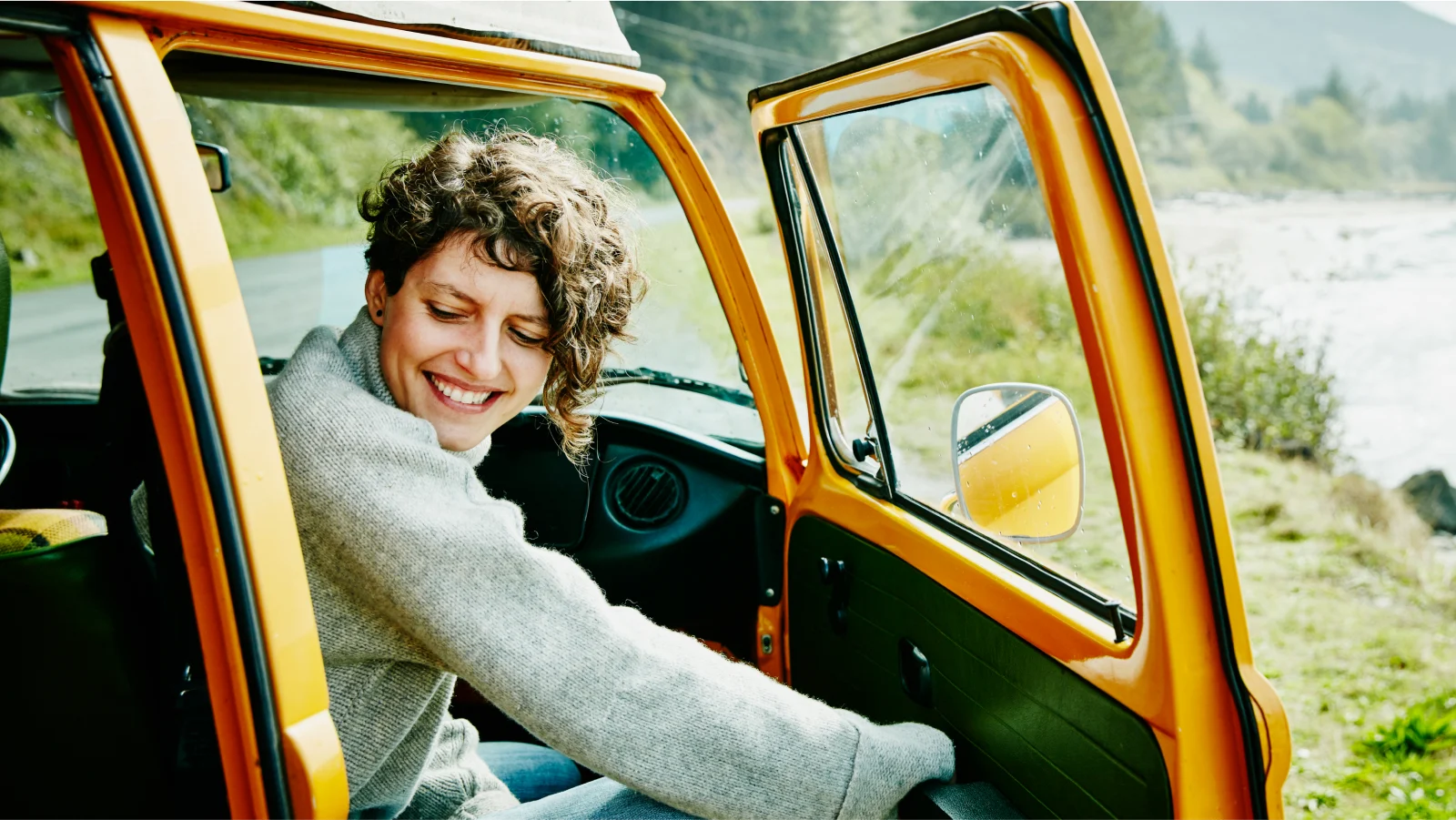 Smiling woman opening her car door to get out