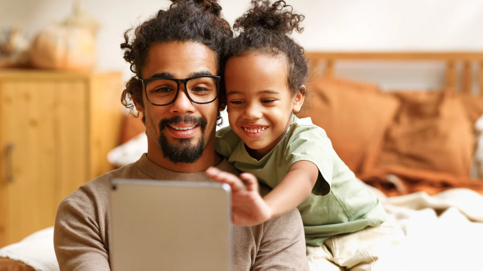 A secure, personalized online platform - father and son looking at tablet