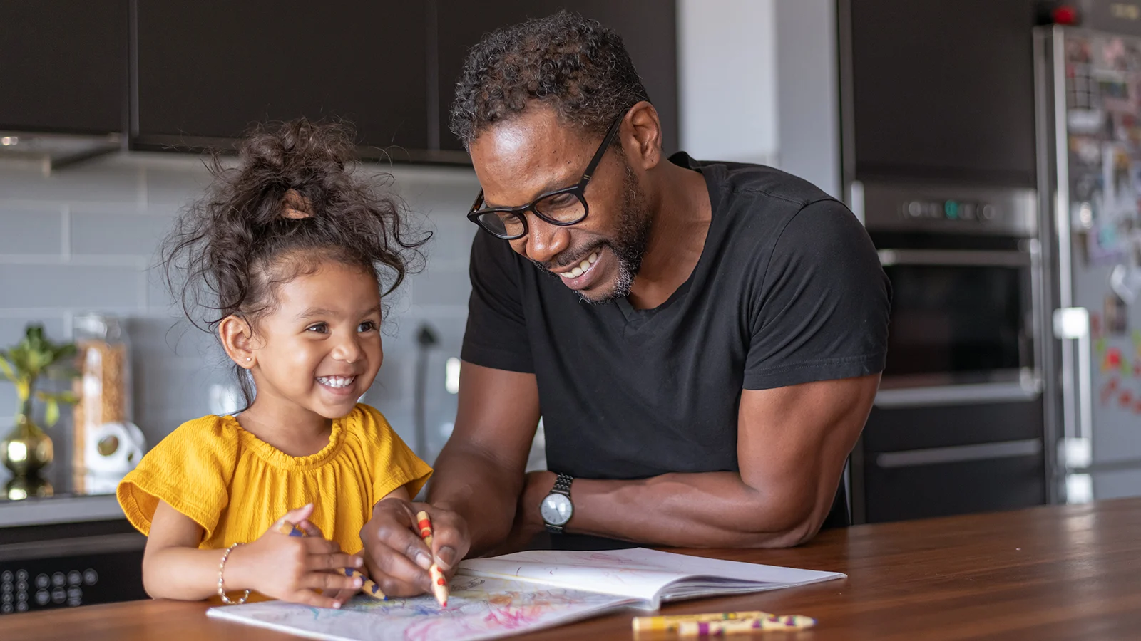 Father coloring with his daughter at home