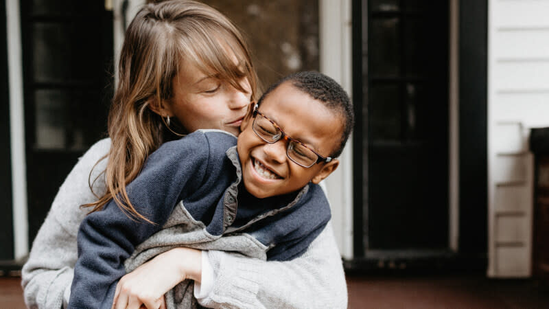 child with glasses with parent