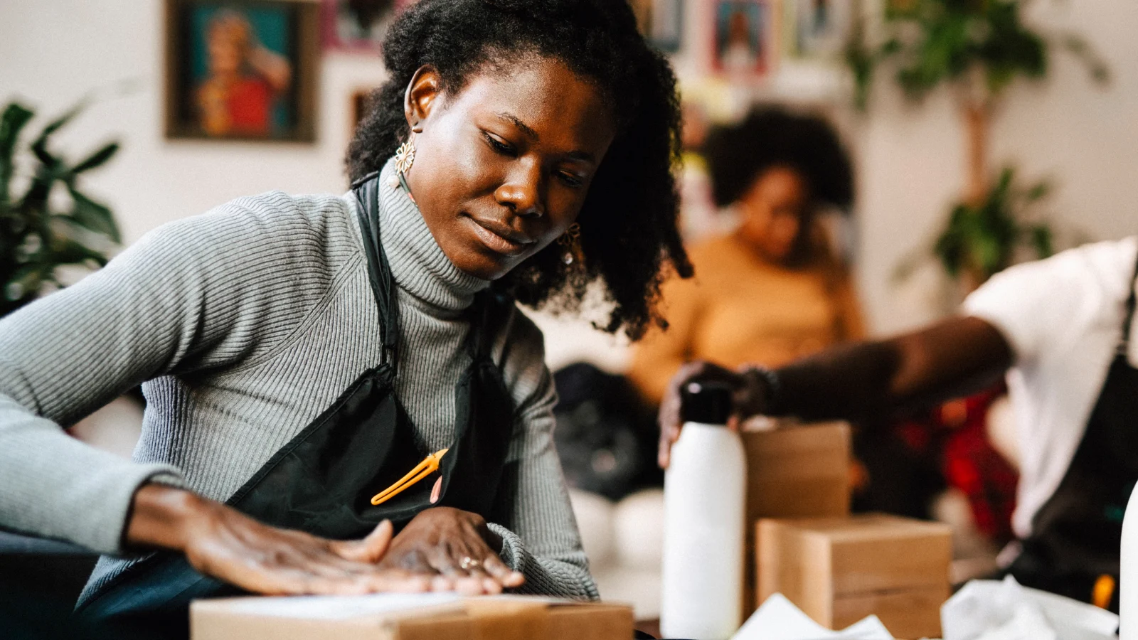 A dedicated mental wellness solution - Woman at work sealing a package