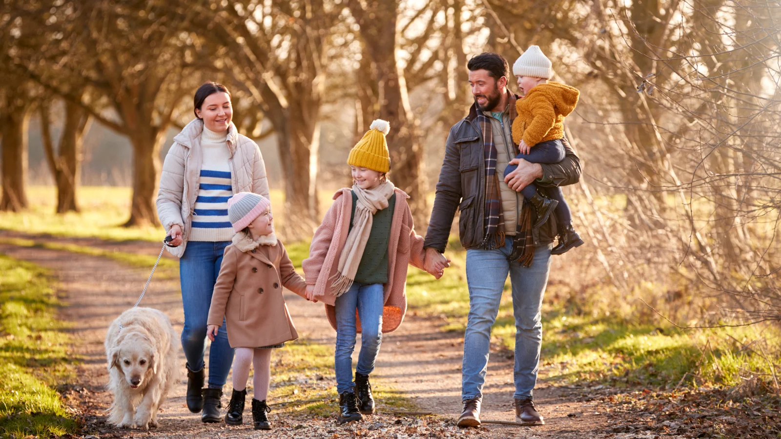 Family walking with pet dog