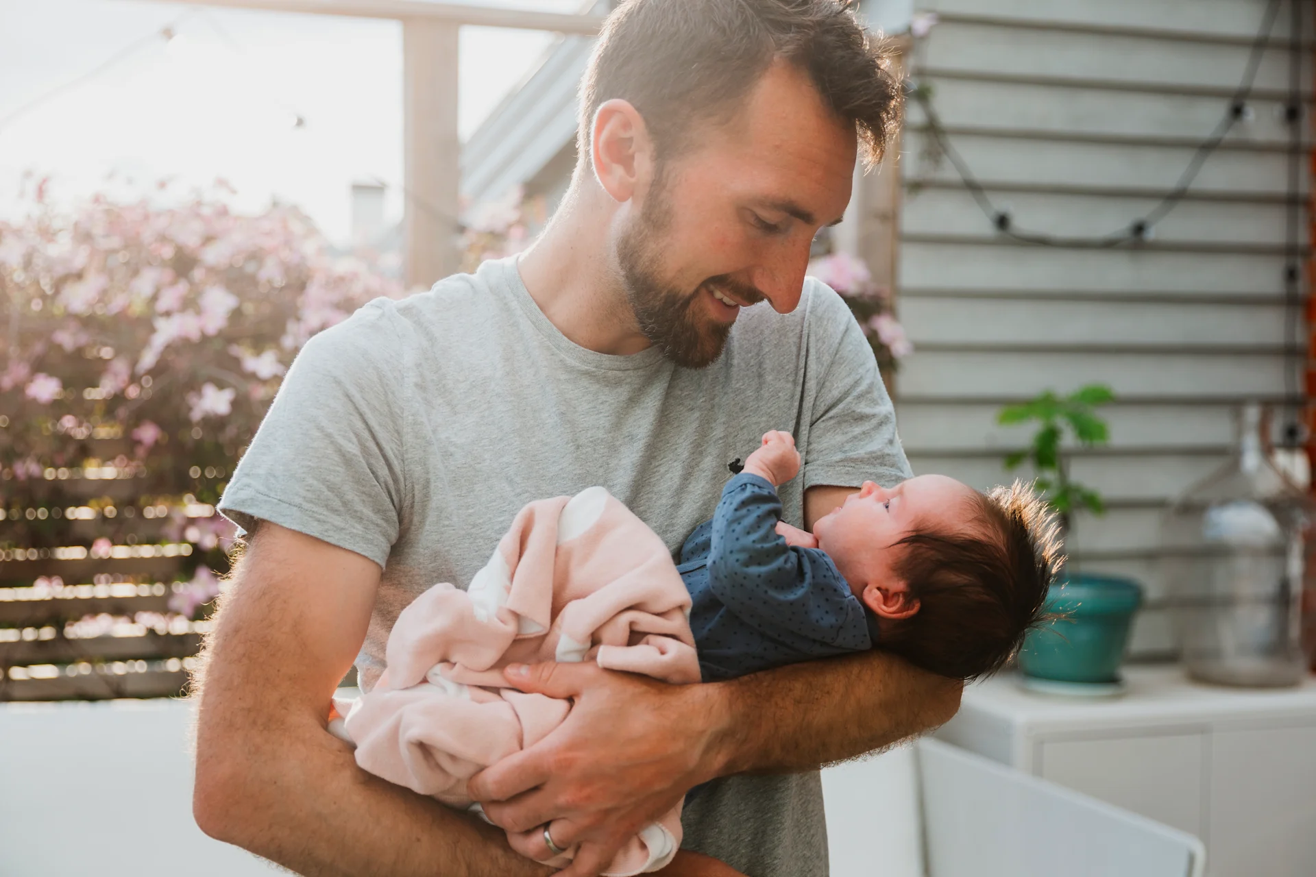 Father holding his daughter outside