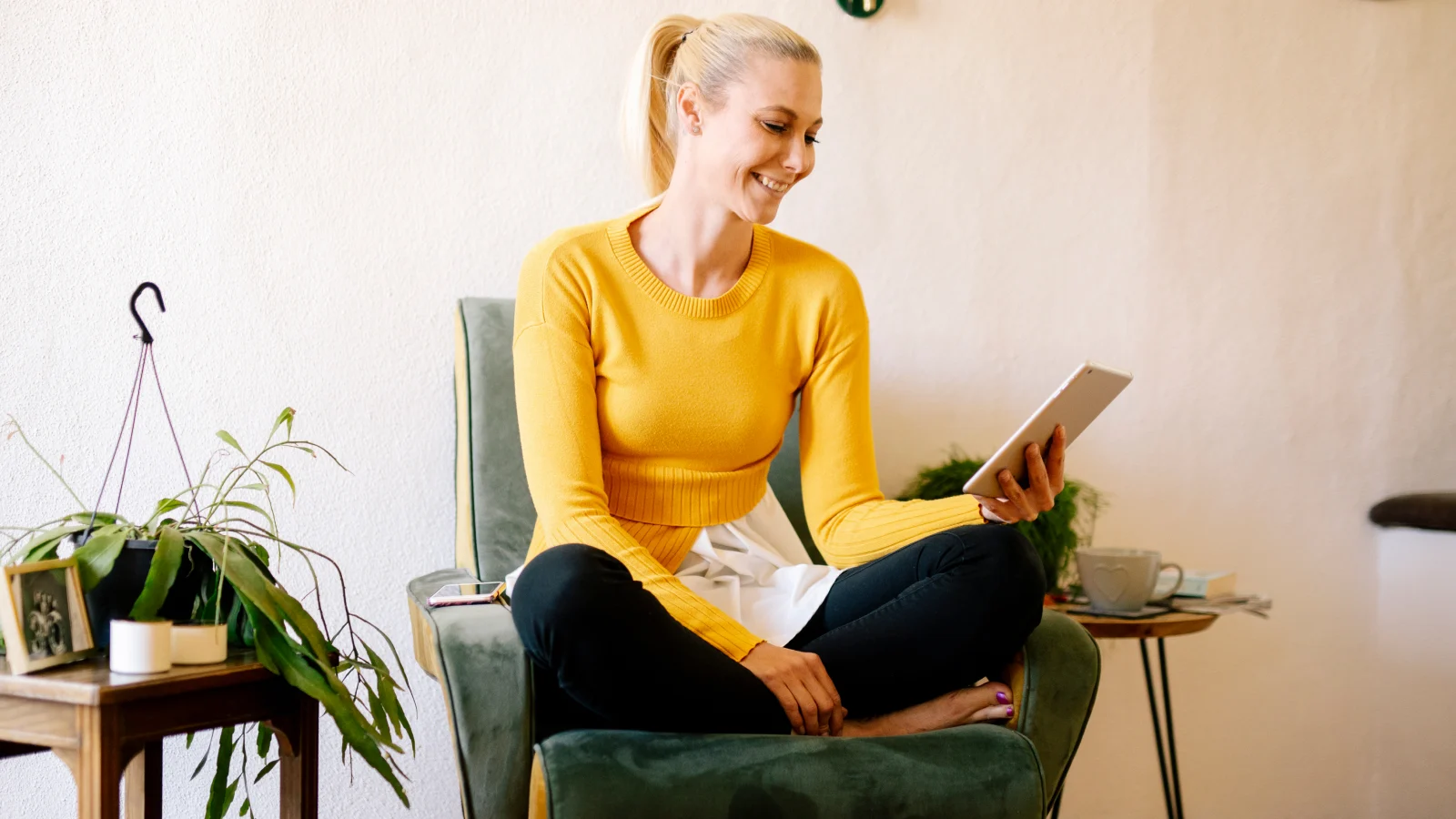 Coaching for a tough, rewarding job - woman sitting on chair looking at tablet