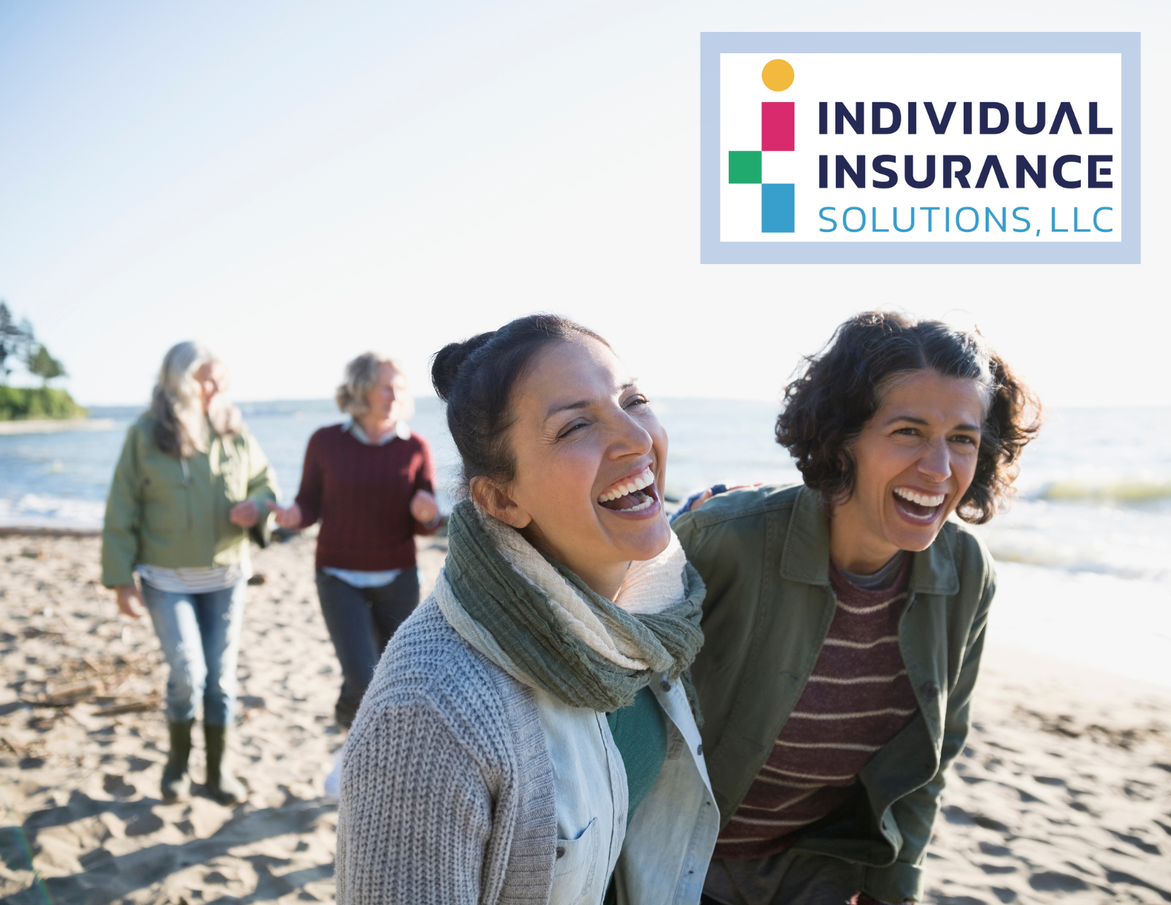 Two women laughing on beach, used as hero image for IIS landing page and has the standard IIS logo in top right corner