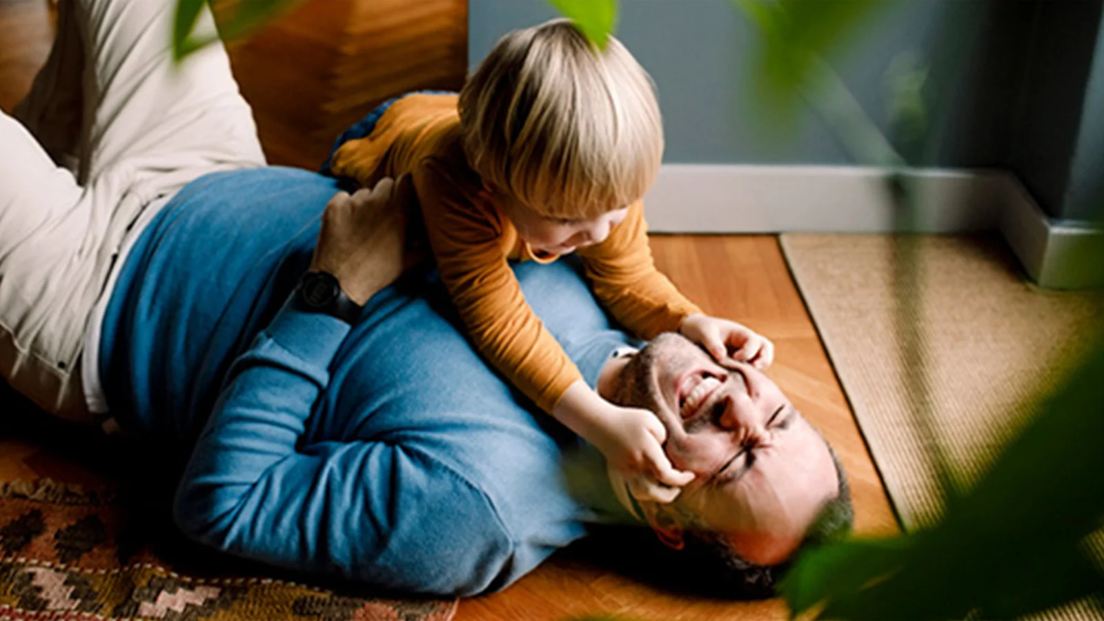 No matter your definition of family, we know it’s important to you. - Father and son playing and laughing together