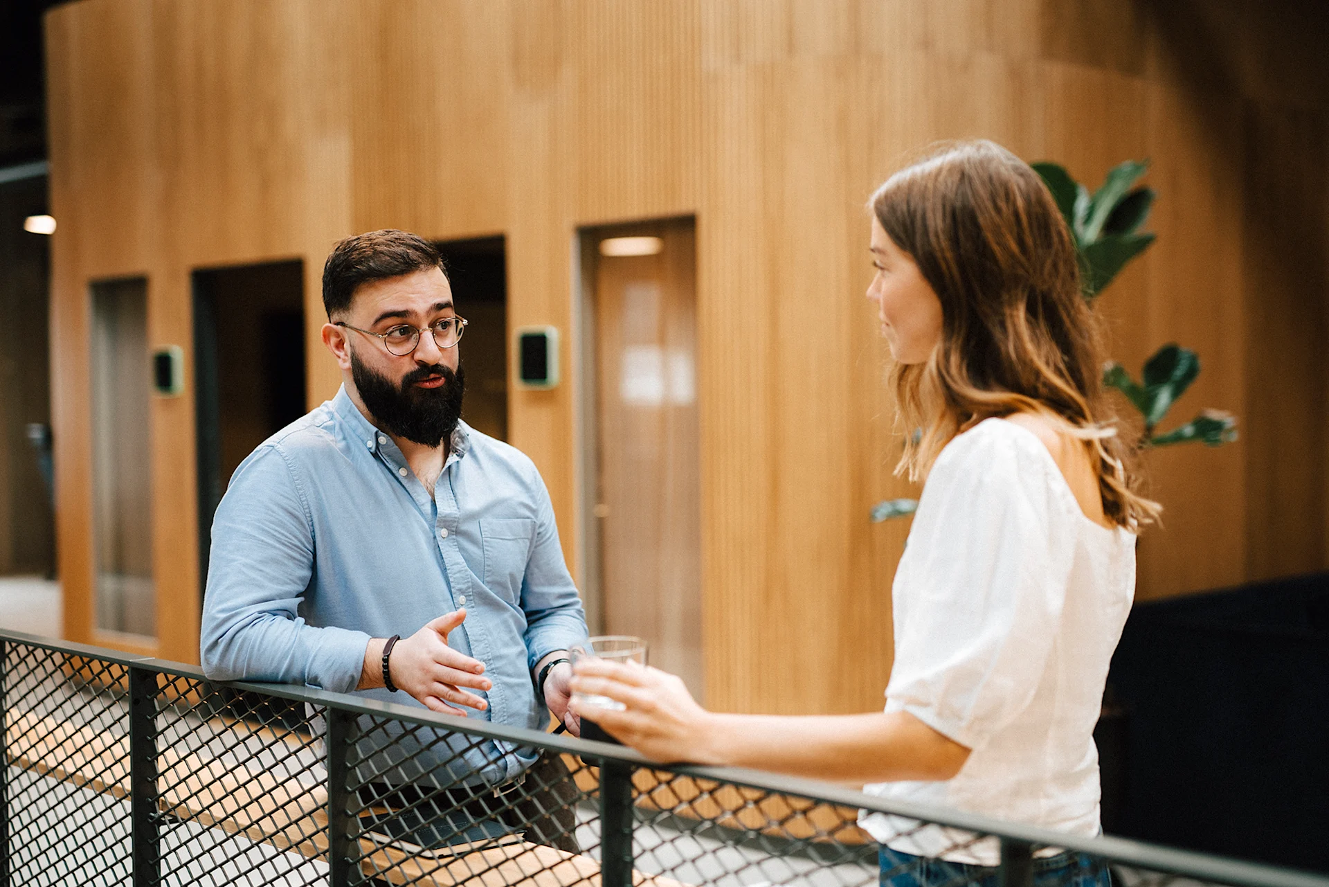 Employee and their manager speaking in a hallway.